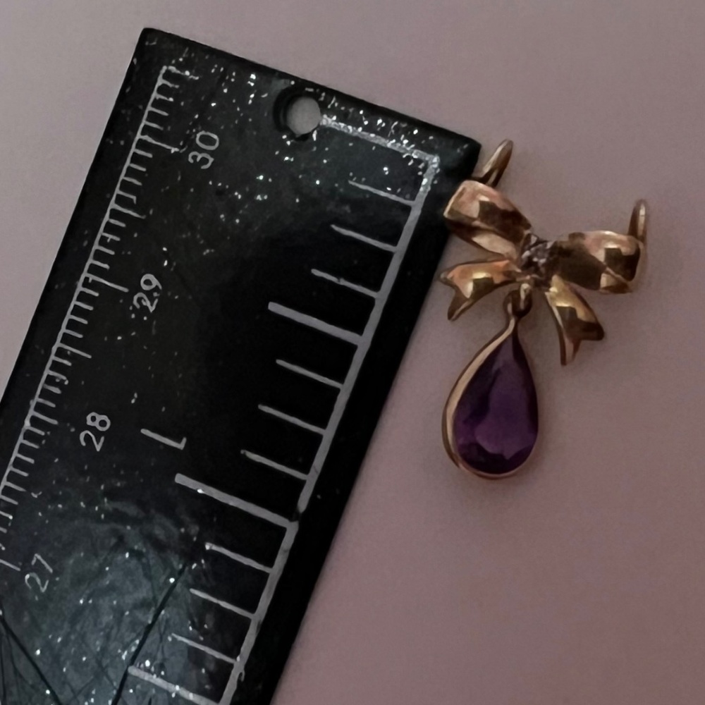 10k diamond and purple stone pendant.